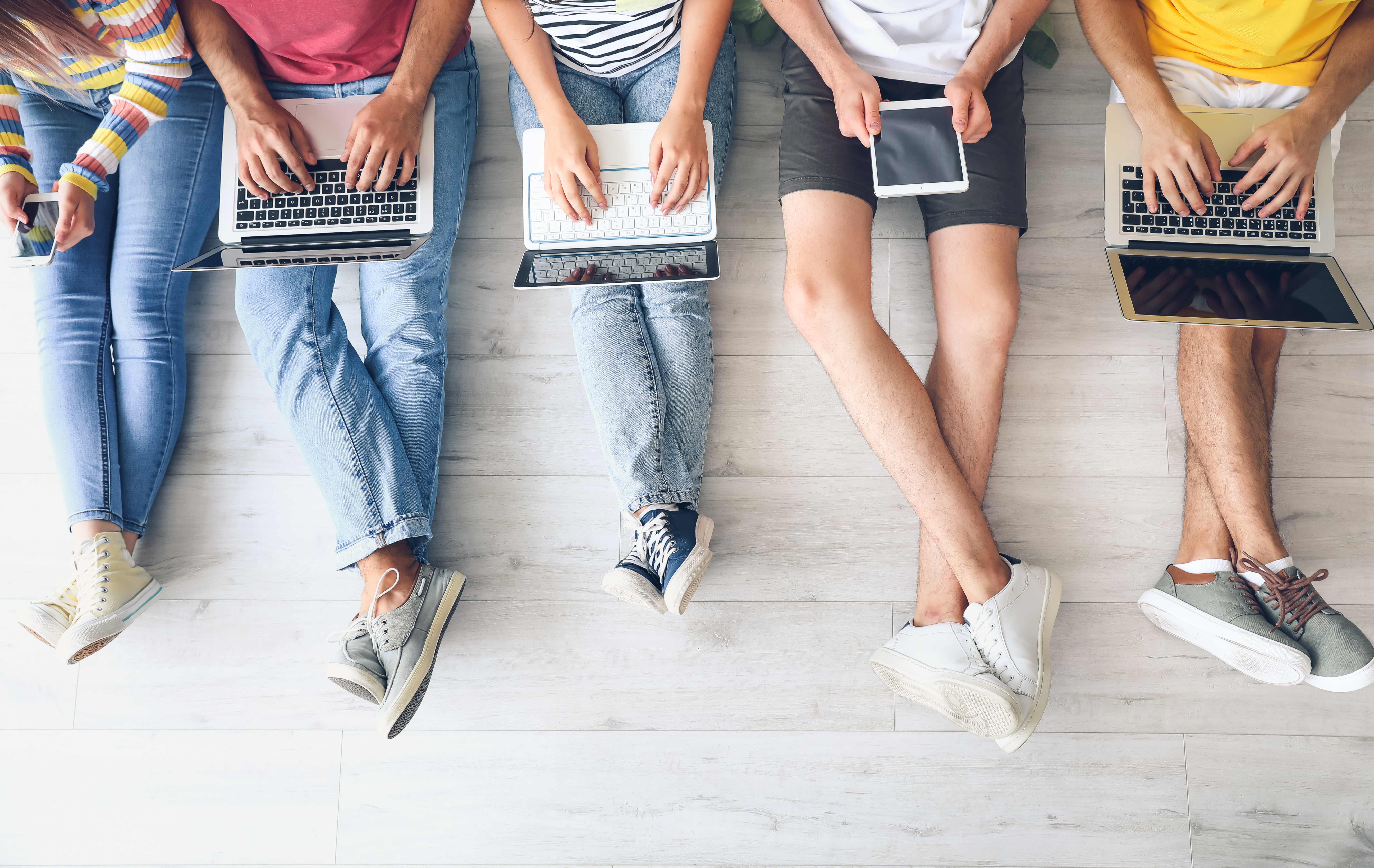 Students with modern devices studying online indoors