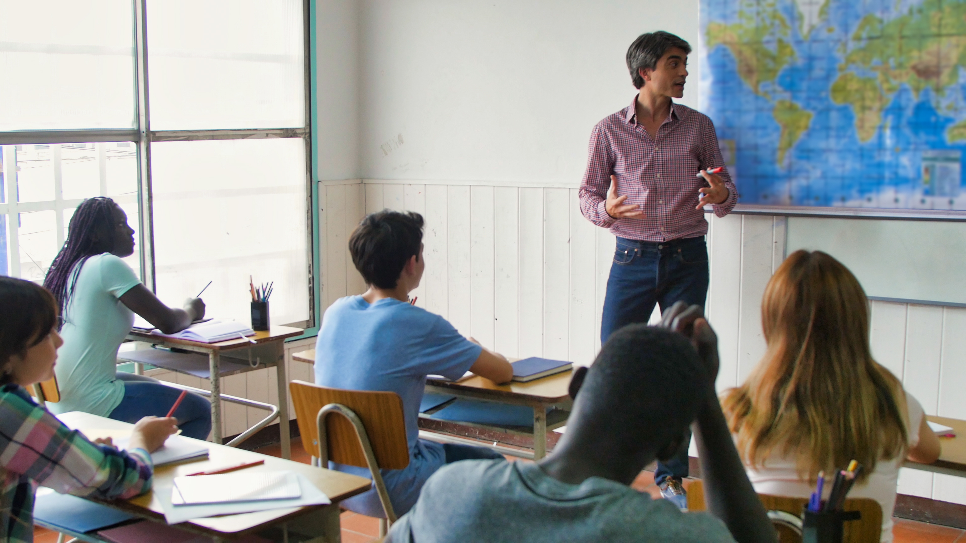 Teacher in the teenagers classroom during school lesson.
