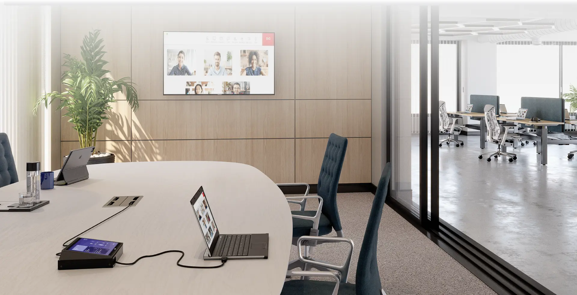 Modern conference room with retractable tabletop connectivity, video collaboration displays, and an adjacent shared workspace.
